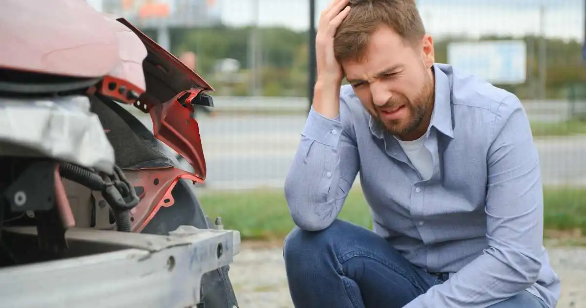 Man experiencing headache after a car accident while considering medical imaging