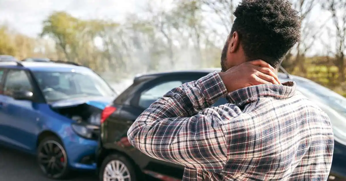 Man experiencing neck pain and stiffness days after a car accident