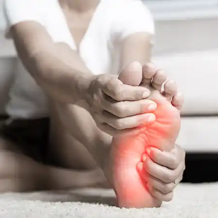 Patient experiencing neuropathy symptoms in feet with burning and numbness